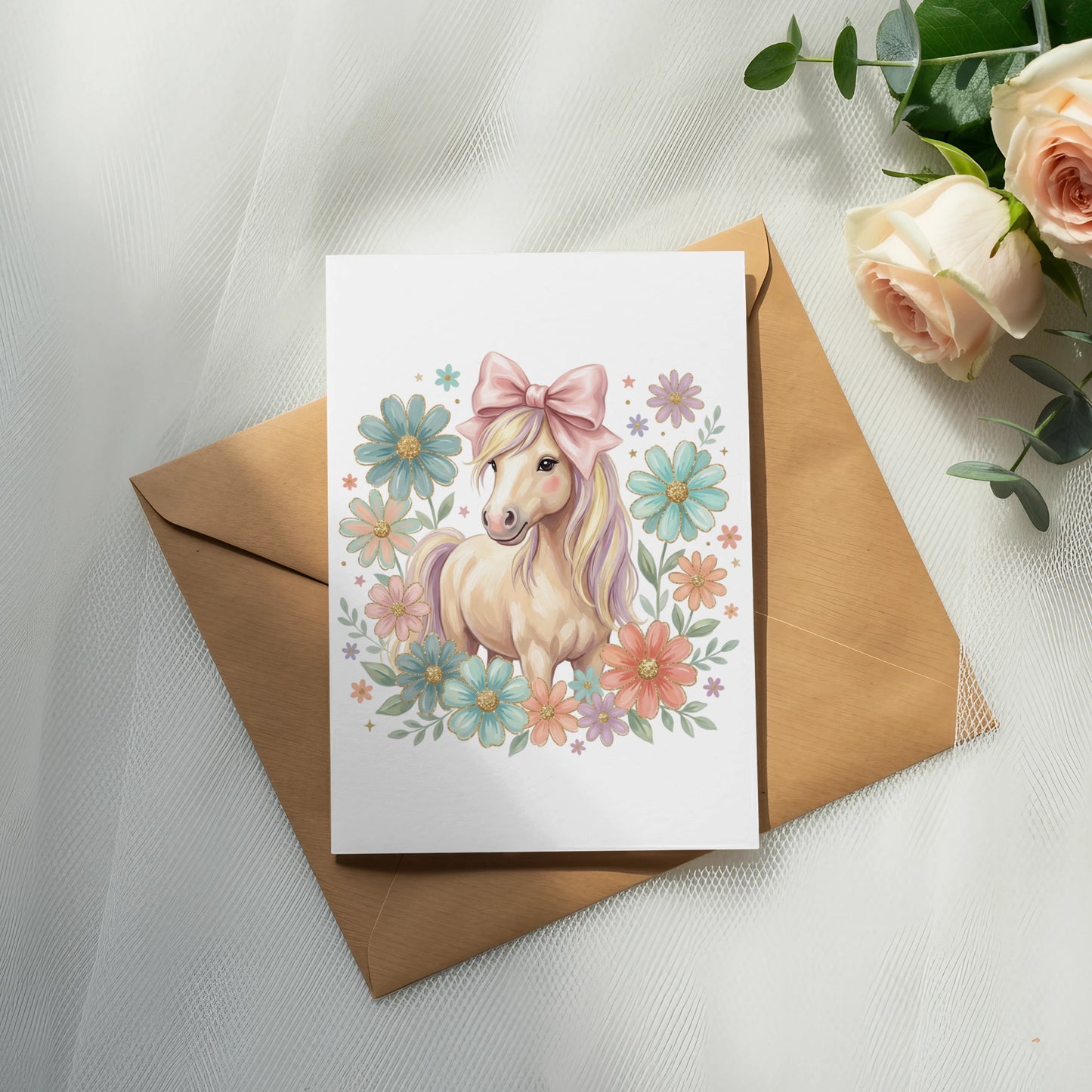Watercolor unicorn illustration with flowers and a pink bow on a greeting card.