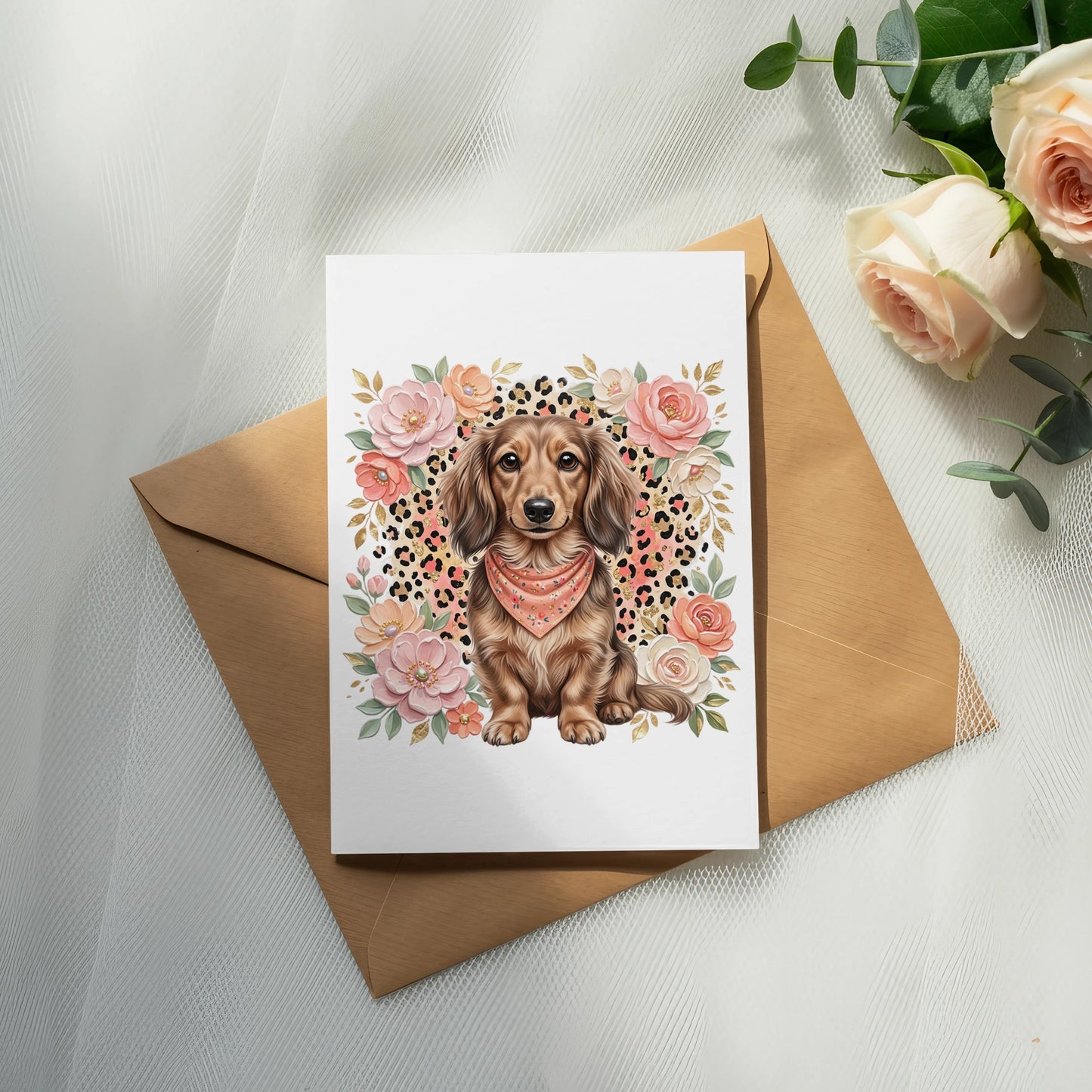 Dachshund wearing bandana sits on a card surrounded by flowers.