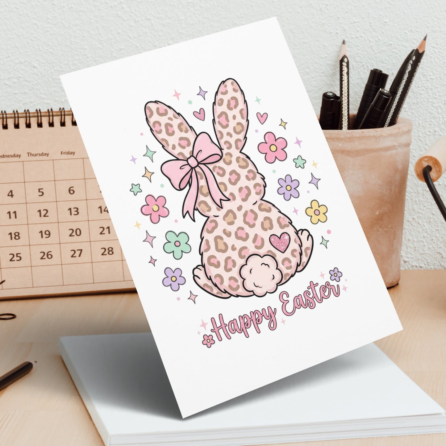 Leopard print Easter bunny with pink bow and "Happy Easter" text.