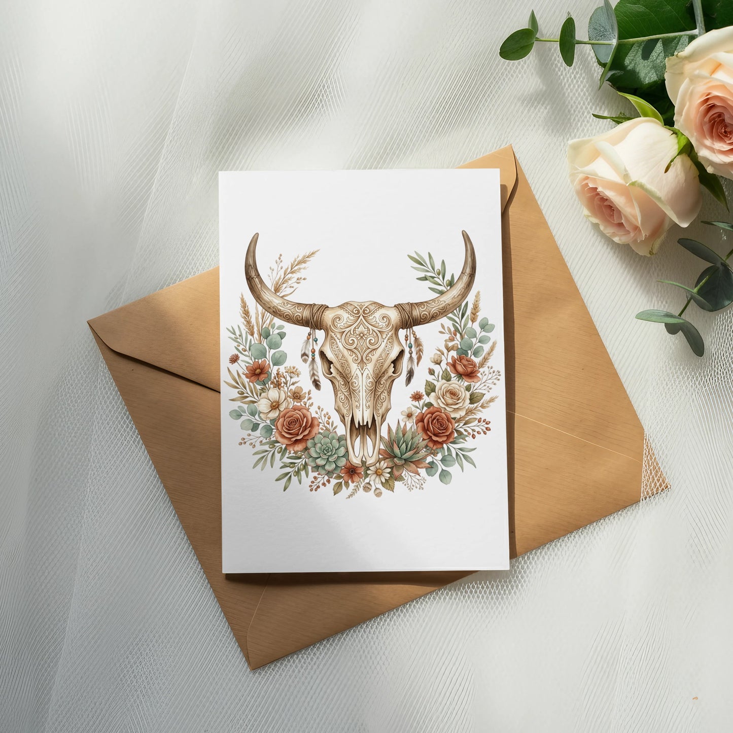Boho floral arrangement surrounds a bull skull on an open envelope.