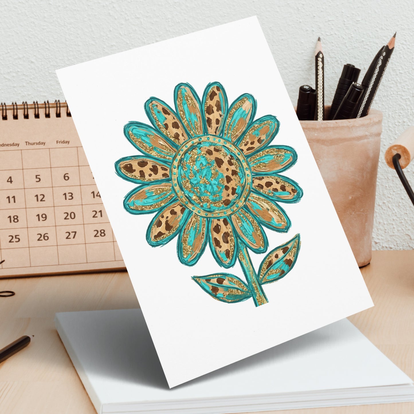 Turquoise and gold leopard print sunflower drawing on a white card.