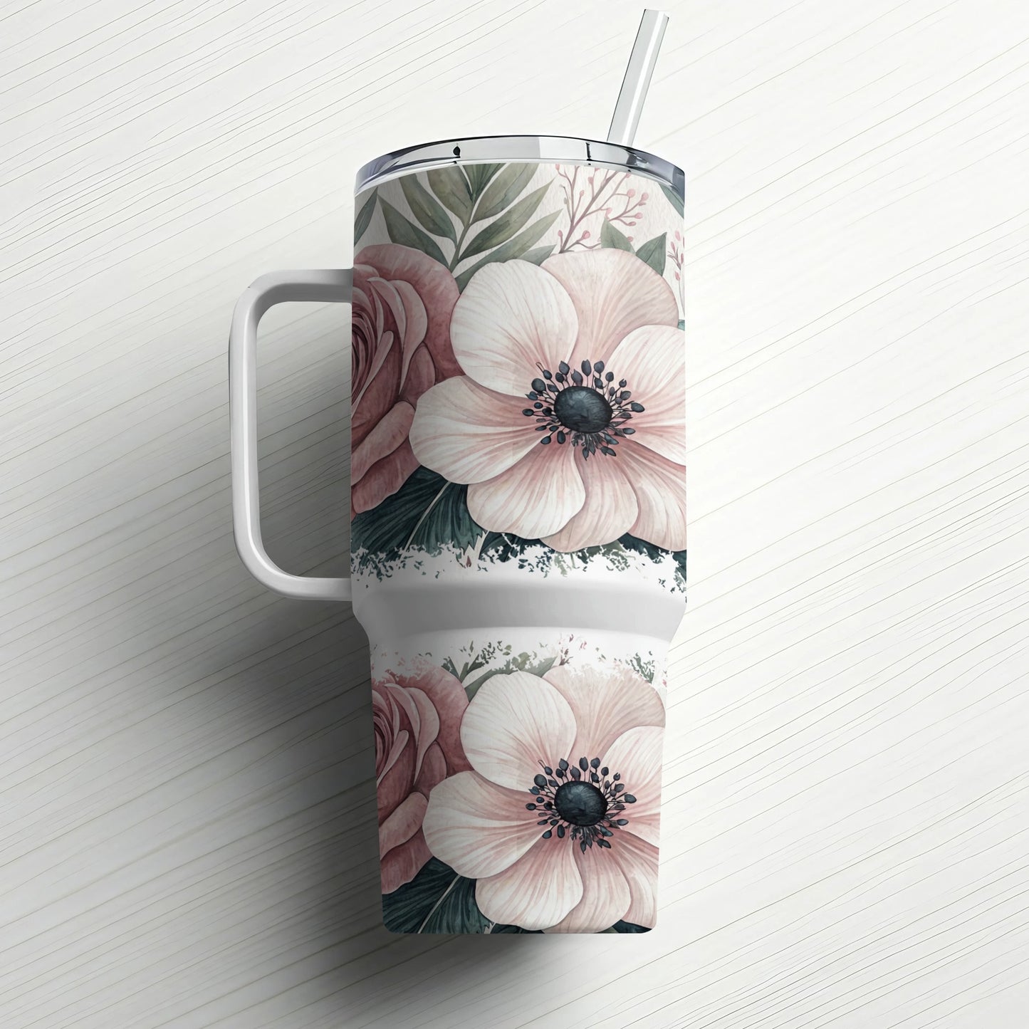 Tumbler with blush pink and white floral pattern and straw.