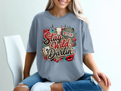 T-shirt with "Stay Wild Darlin'" text, bull skull, dice, cherries, and slot machine.