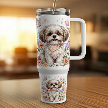 Shih Tzu puppy wearing bandana, surrounded by flowers and butterflies on tumbler.