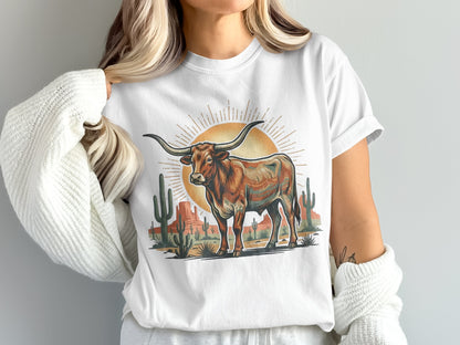 White t-shirt with a colorful longhorn steer in a desert landscape.