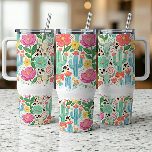Three tumblers with a floral, cactus, and cow skull Western design.