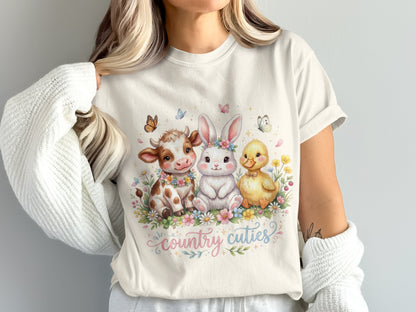 Cream t-shirt with watercolor cow, bunny, and ducklings in flowers, text "country cuties".