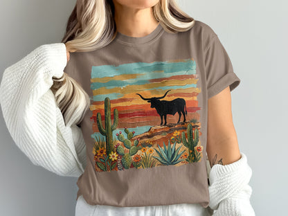 Brown t-shirt with desert landscape, longhorn cattle, and cacti.