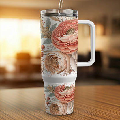 White tumbler with pink and cream floral pattern and handle.