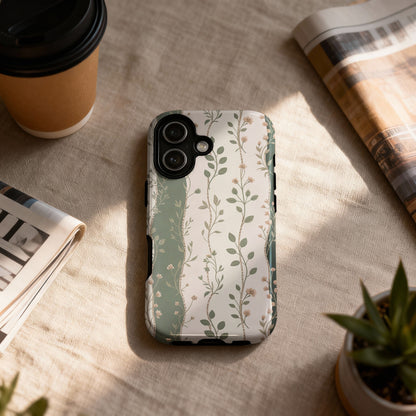 Phone case with a muted floral and vine pattern on a textured surface.