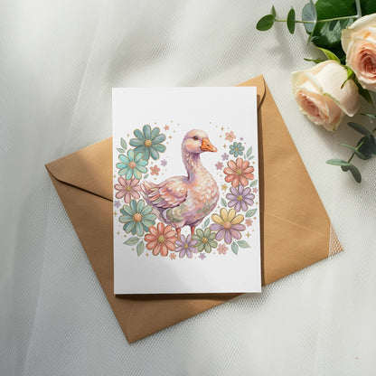 Watercolor illustration of a duck surrounded by colorful flowers on a greeting card.