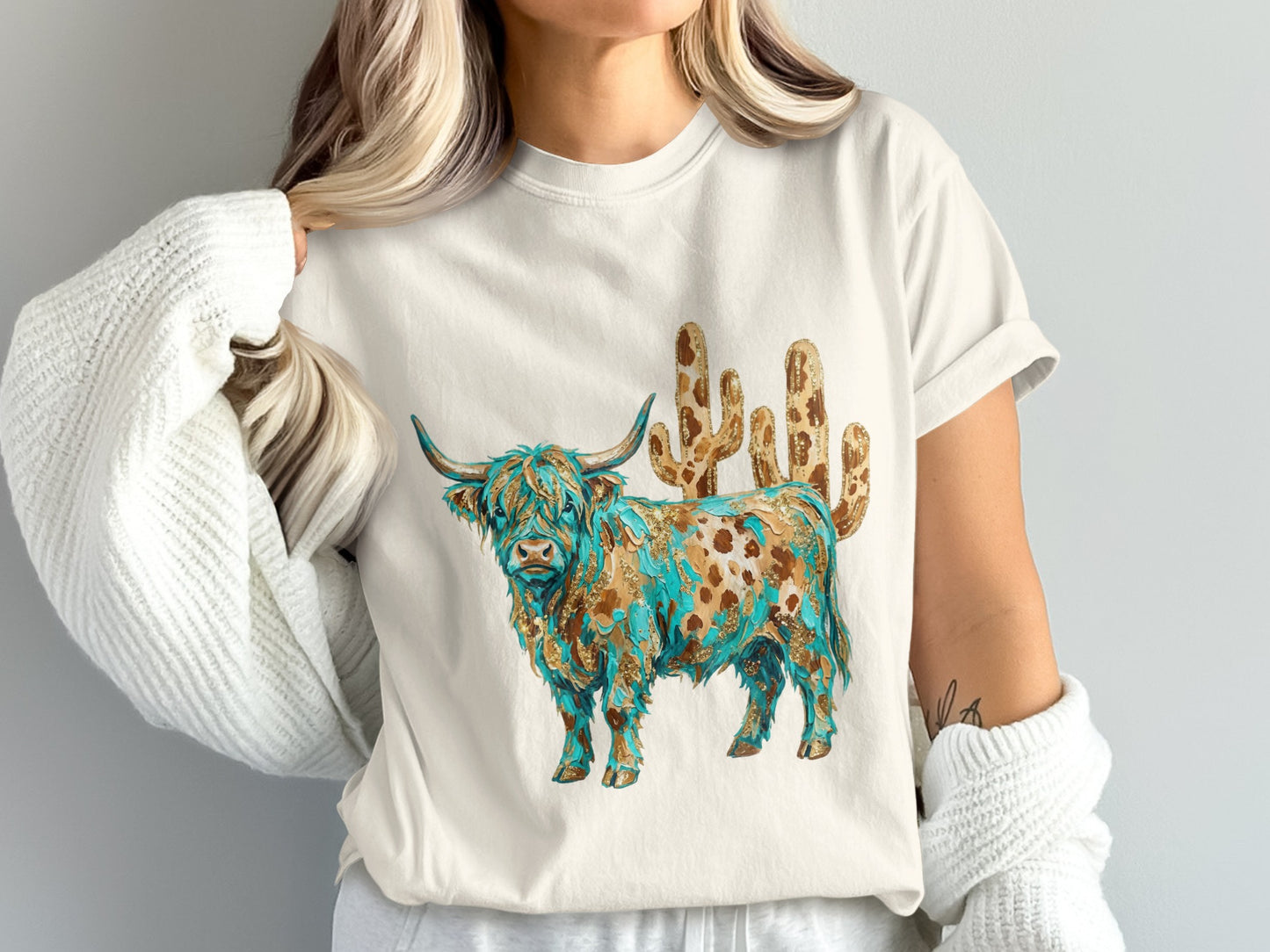 Cream t-shirt with a Highland cow and cactus design.