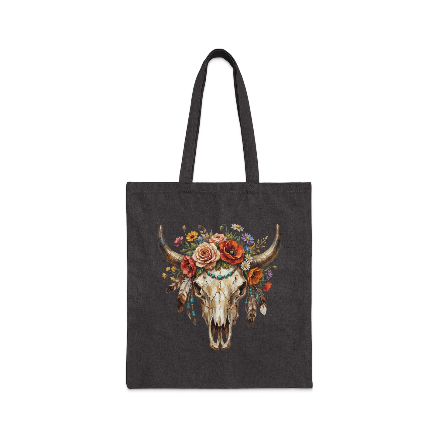 Dark tote bag with a watercolor painting of a bull skull adorned with flowers and feathers.