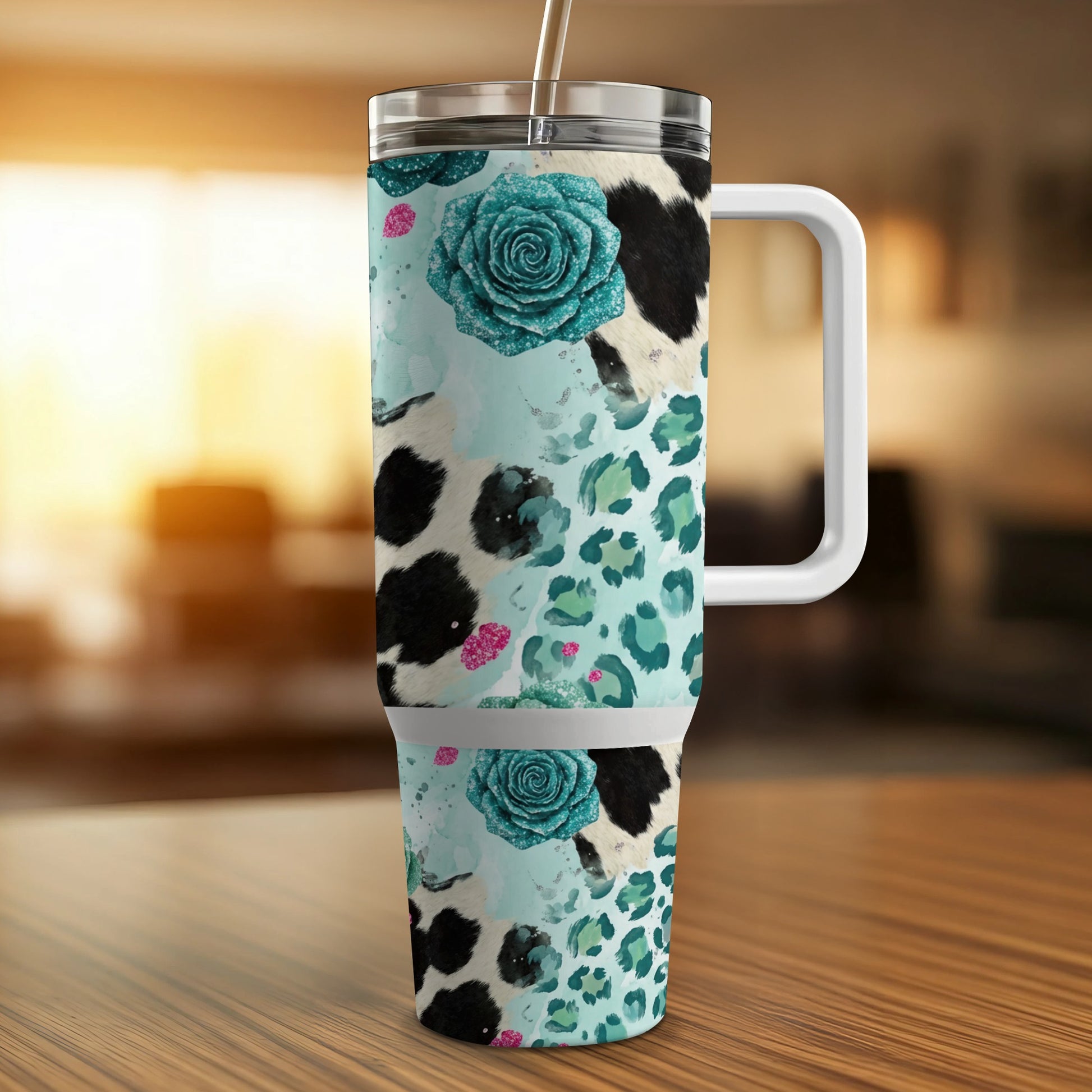 Cow print, leopard print, and teal glitter floral tumbler with white handle.