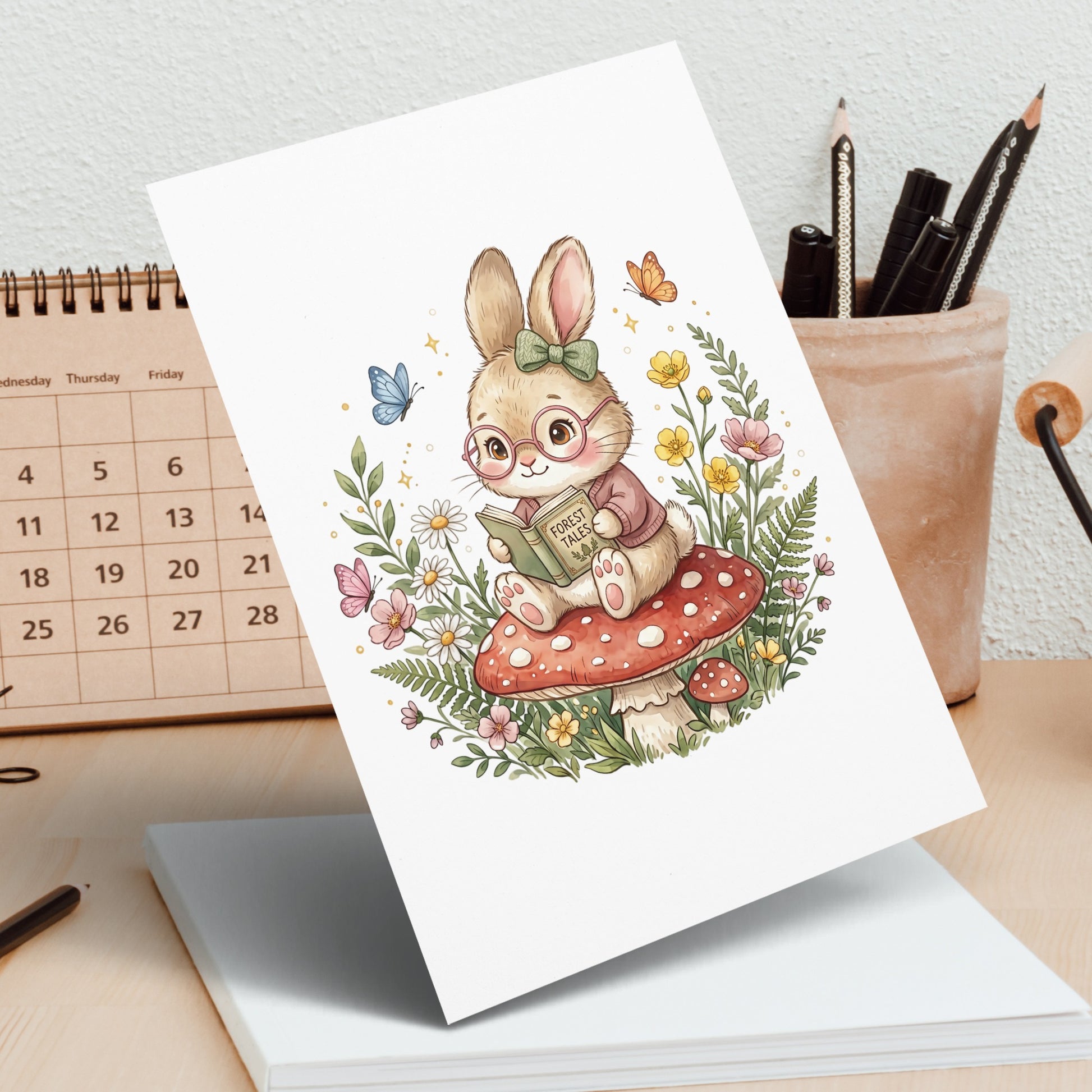 Illustration of a rabbit wearing glasses reading a book titled "Forest Tales" on a mushroom.