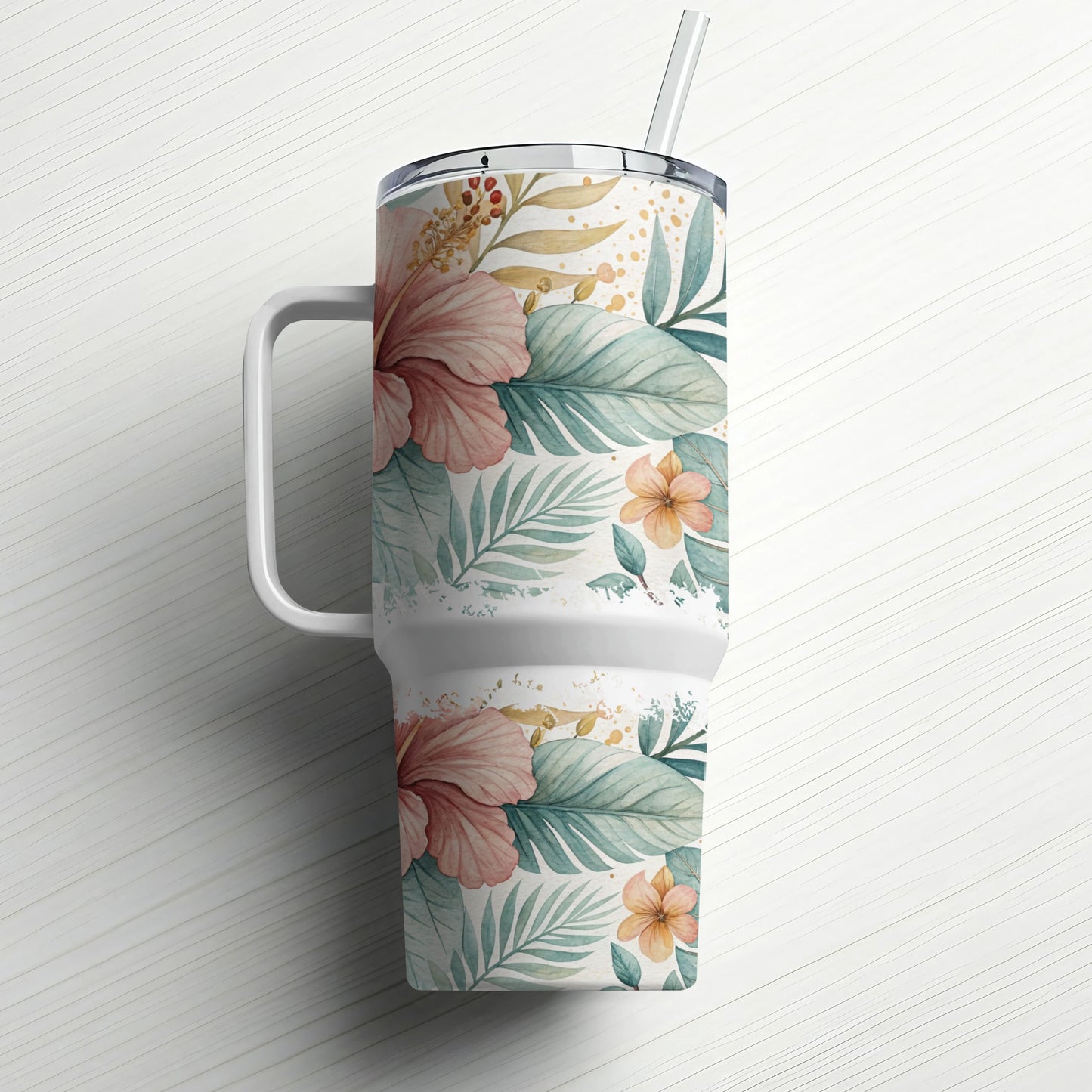 White tumbler with a floral and leaf pattern and a straw.