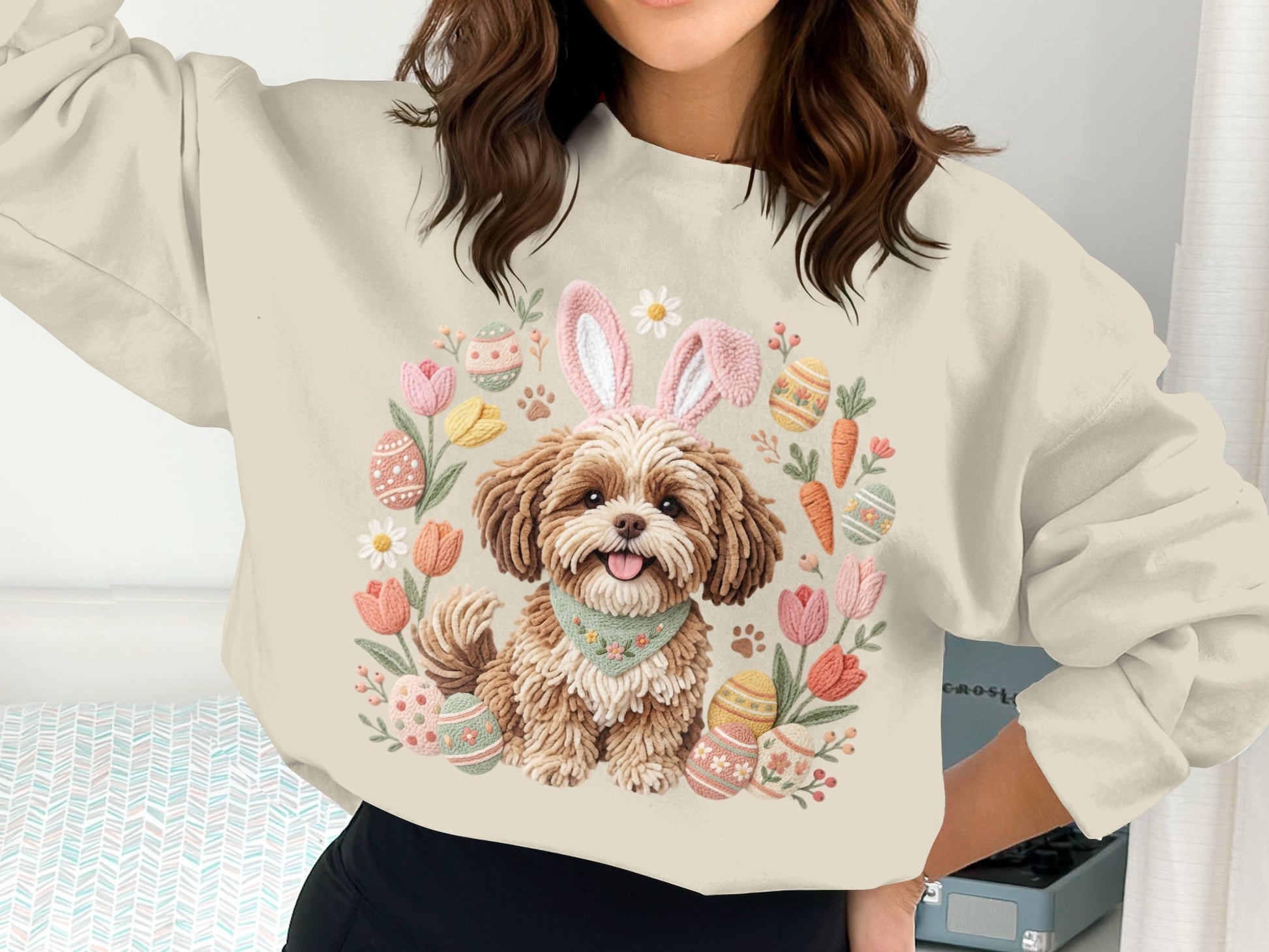 Cream sweatshirt with a cartoon dog wearing bunny ears, surrounded by Easter eggs and carrots.