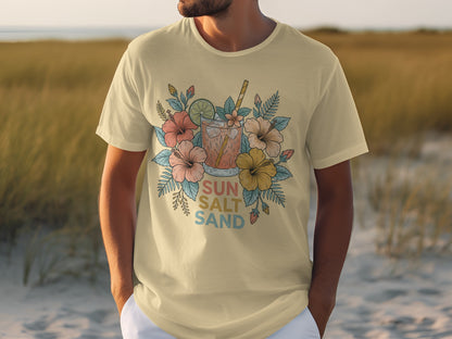 Cream t-shirt with tropical drink and floral design, reads "SUN SALT SAND".