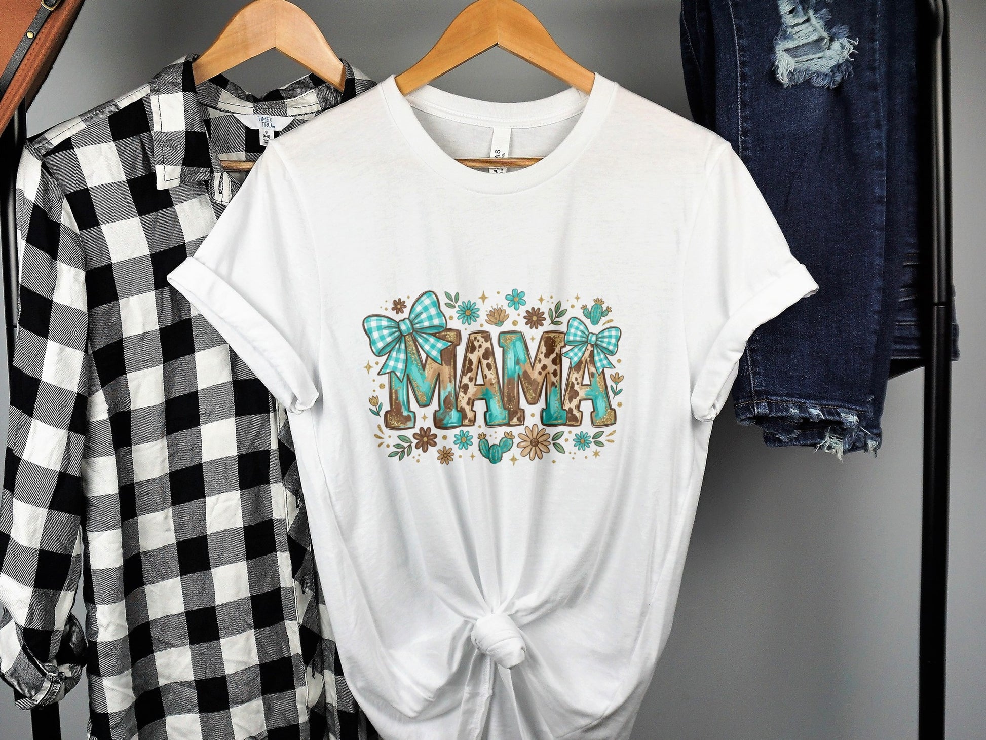 White t-shirt with "MAMA" text and floral, plaid, and animal print accents.