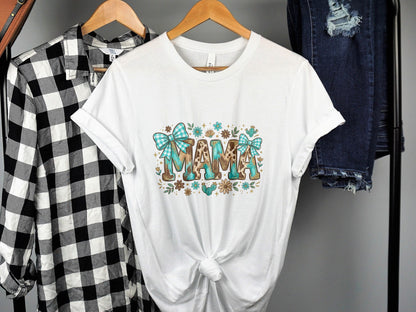 White t-shirt with "MAMA" text and floral, plaid, and animal print accents.