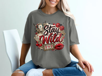 Graphic tee with "Stay Wild" text, dice, cherries, lips, and casino elements.