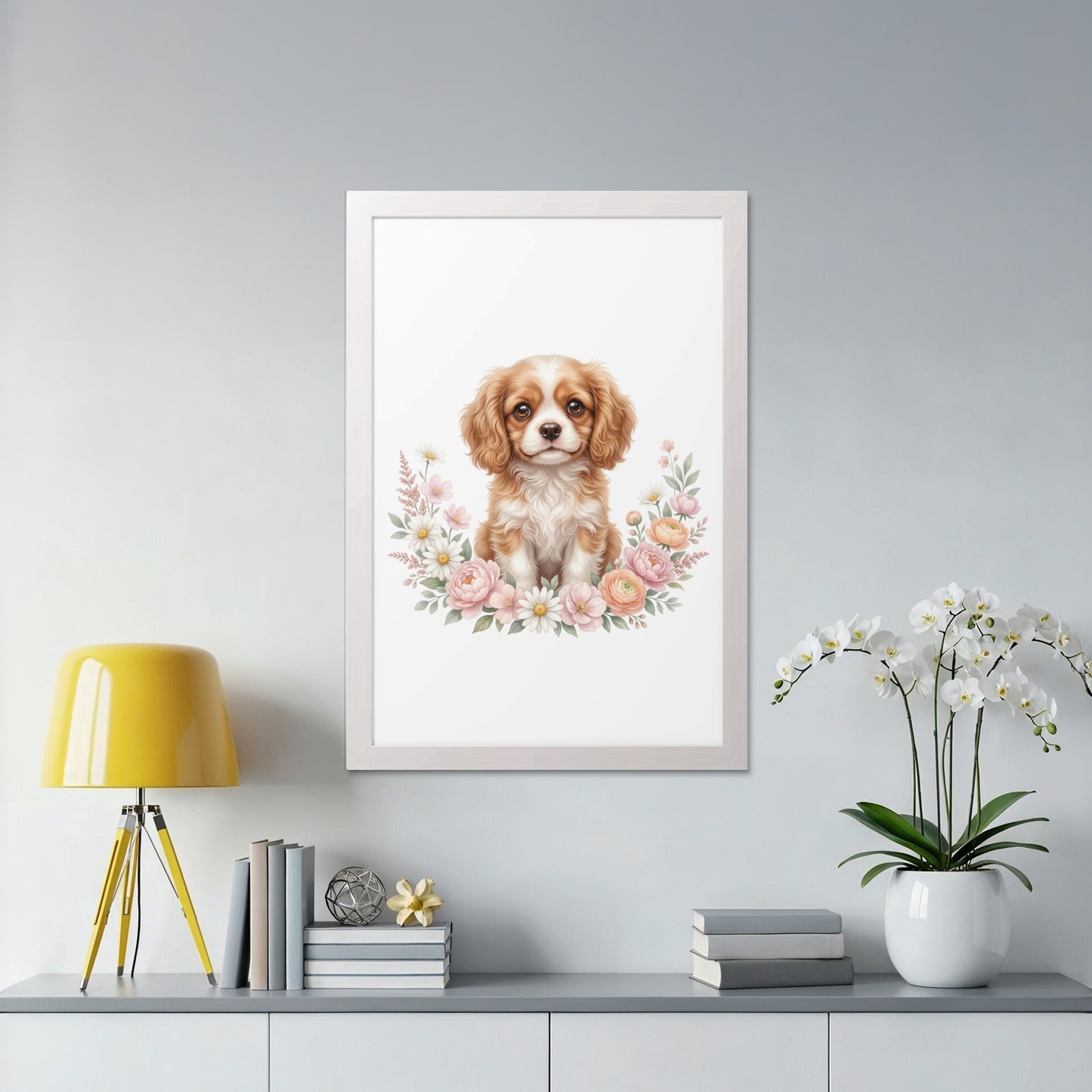 Framed artwork of a Cavalier King Charles Spaniel puppy surrounded by flowers.