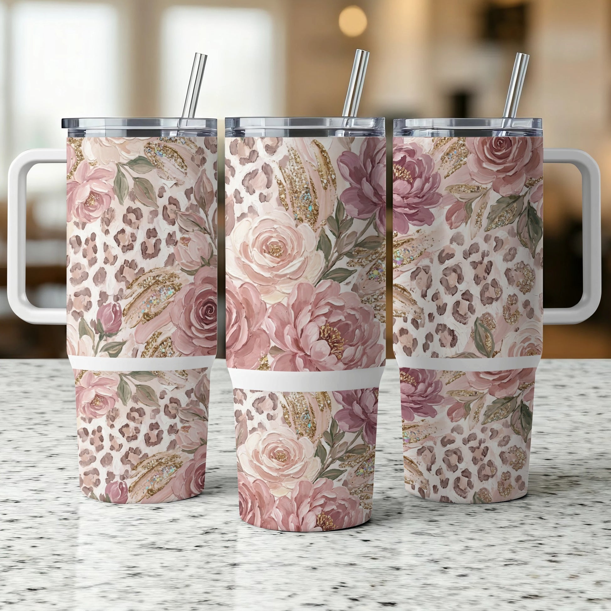 Three floral and leopard print tumblers with handles and straws.