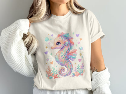 Pastel seahorse with coral and hearts on a cream t-shirt.