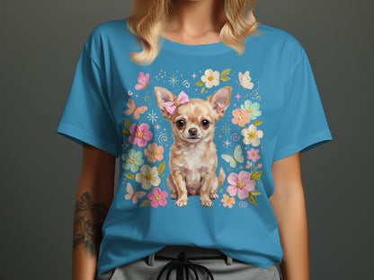 Blue t-shirt with a chihuahua wearing a bow surrounded by flowers and butterflies.