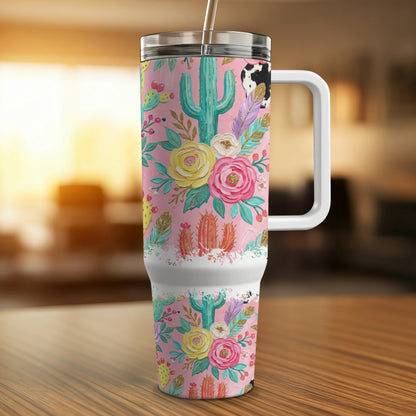 Pink tumbler with cactus, floral, and cow print design.