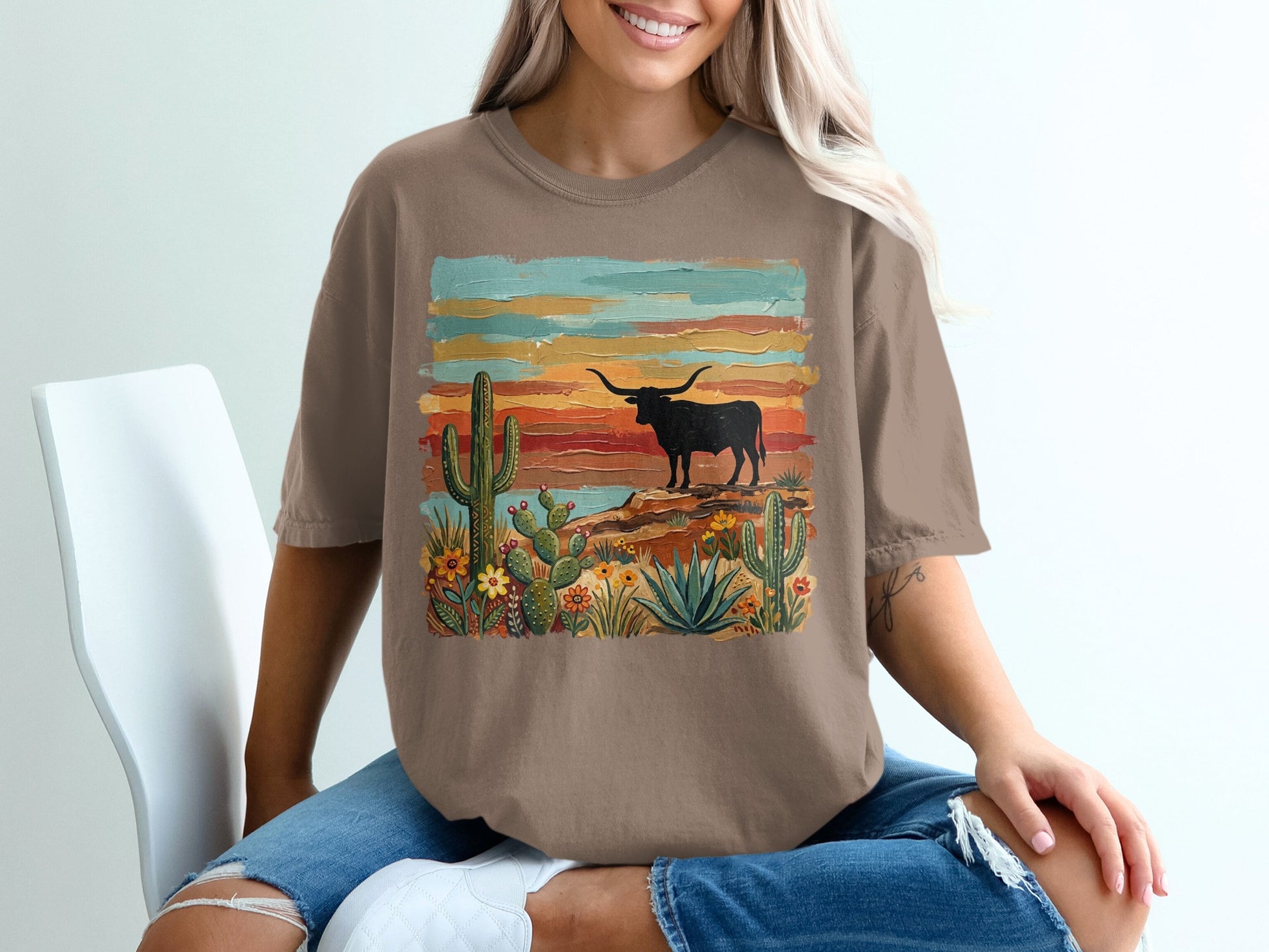 Brown t-shirt with desert scene featuring longhorn bull and cacti.