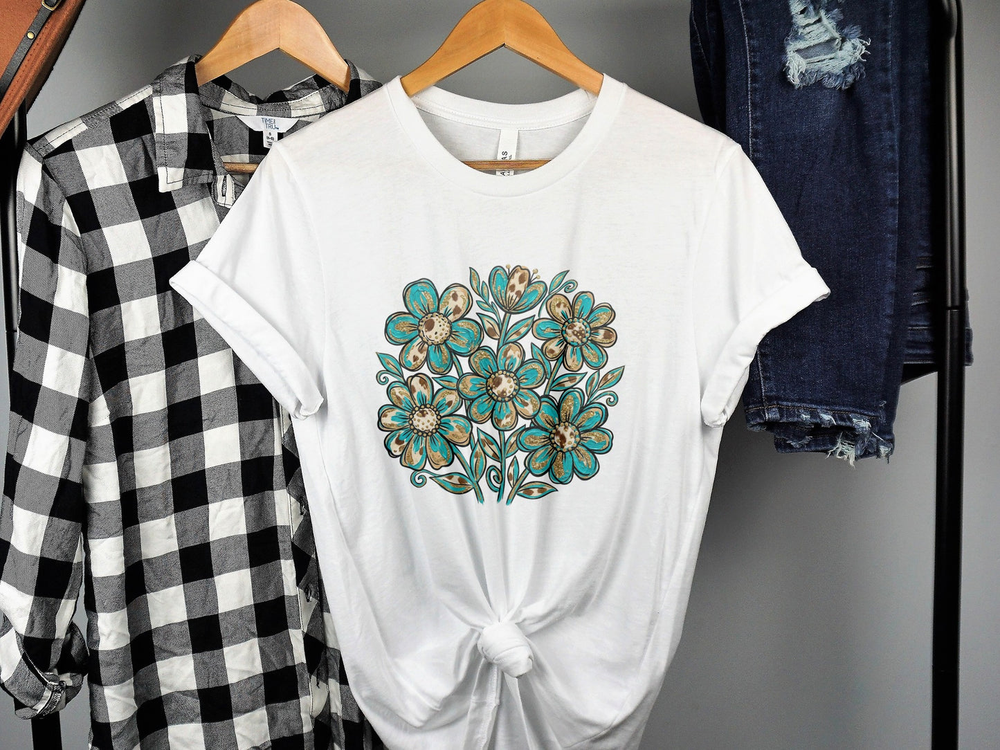 White t-shirt with a floral pattern in brown and teal colors.