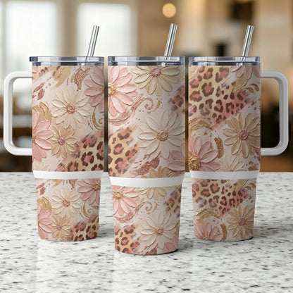 Three tumblers with floral and leopard print patterns on a speckled countertop.
