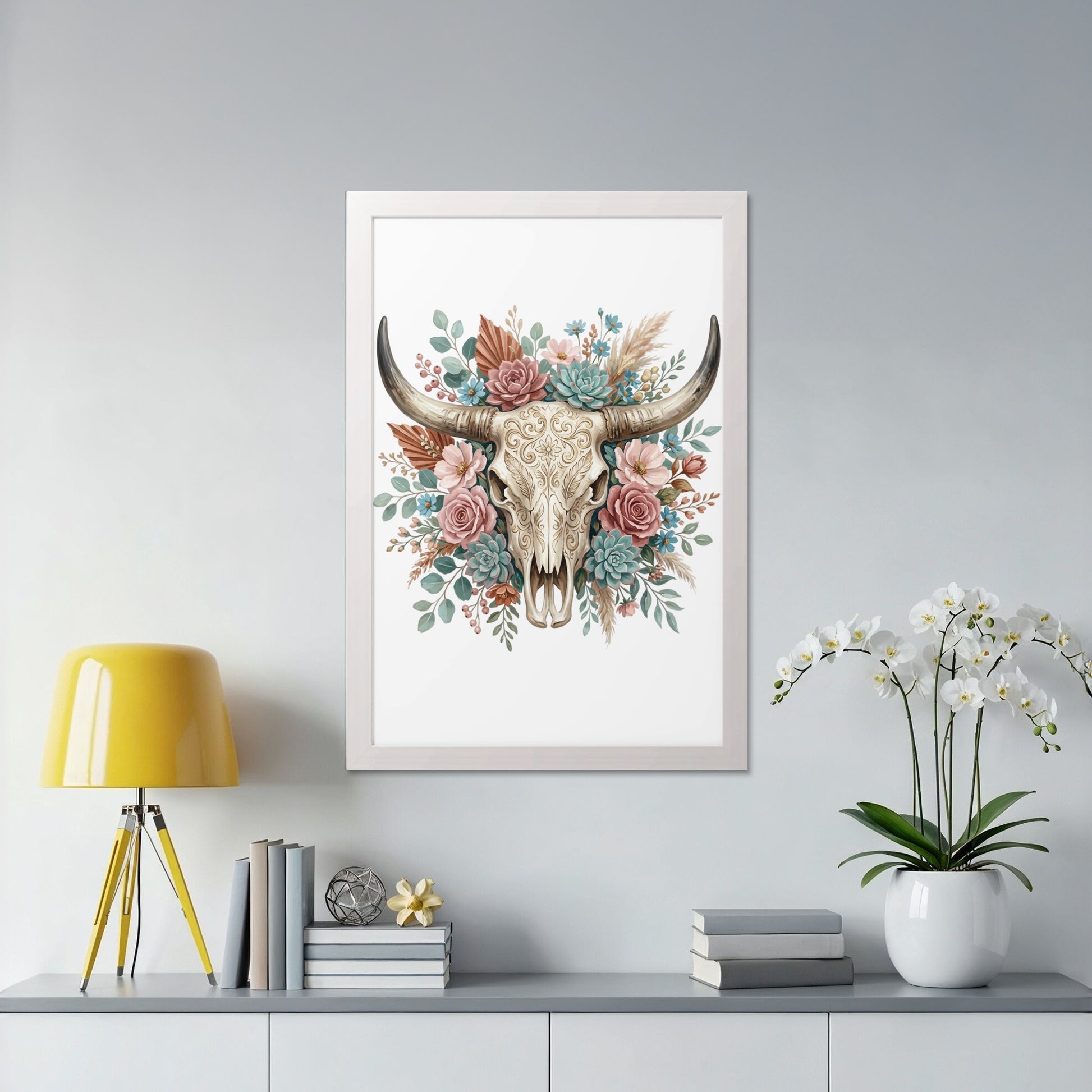 Framed floral arrangement with a bull skull and succulents.