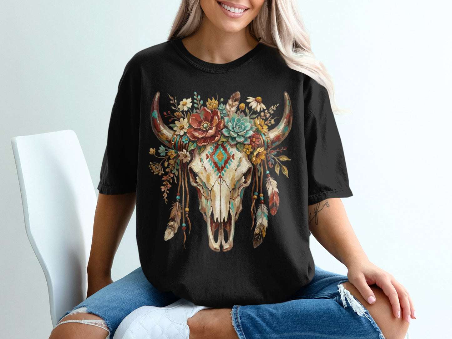 Black t-shirt with a distressed bull skull adorned with colorful floral and feather headdress.