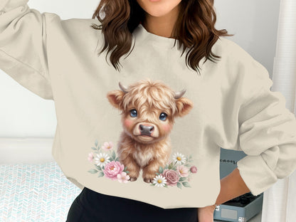 Cream sweatshirt with cute baby highland cow illustration surrounded by flowers.