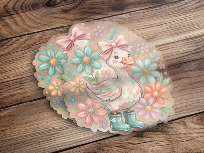 Cute duck wearing blue boots and a pink bow, surrounded by flowers.
