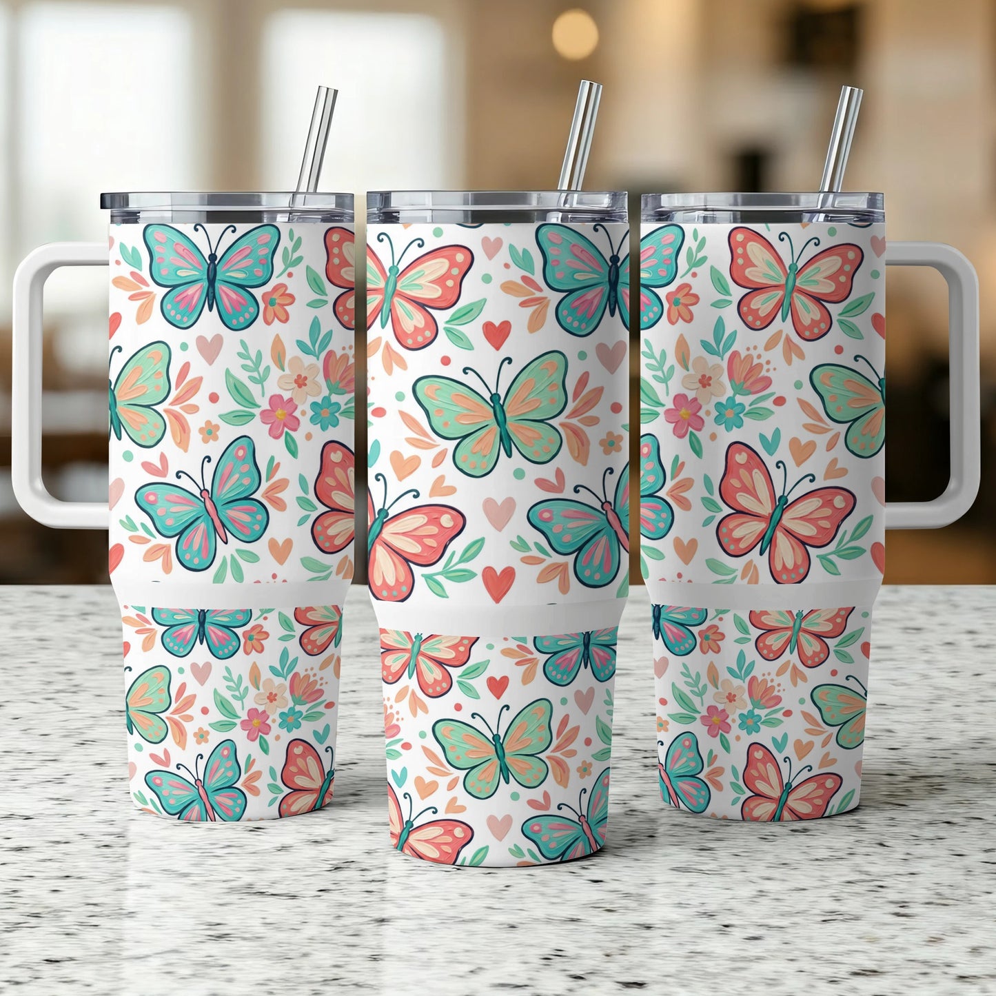 Three insulated tumblers with a repeating butterfly and floral pattern.