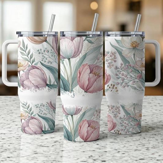 Three tumblers with a floral pattern of pink tulips and green leaves.