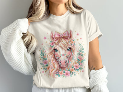 Cream t-shirt with a watercolor horse graphic adorned with flowers and a bow.
