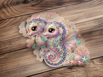 Two glittery seahorses surrounded by coral and starfish.