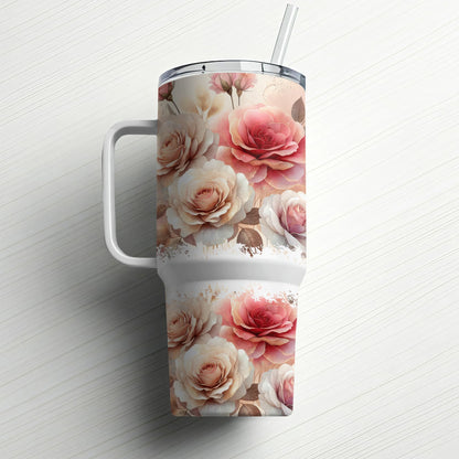 Pink and cream roses adorn a large white tumbler with a straw and handle.