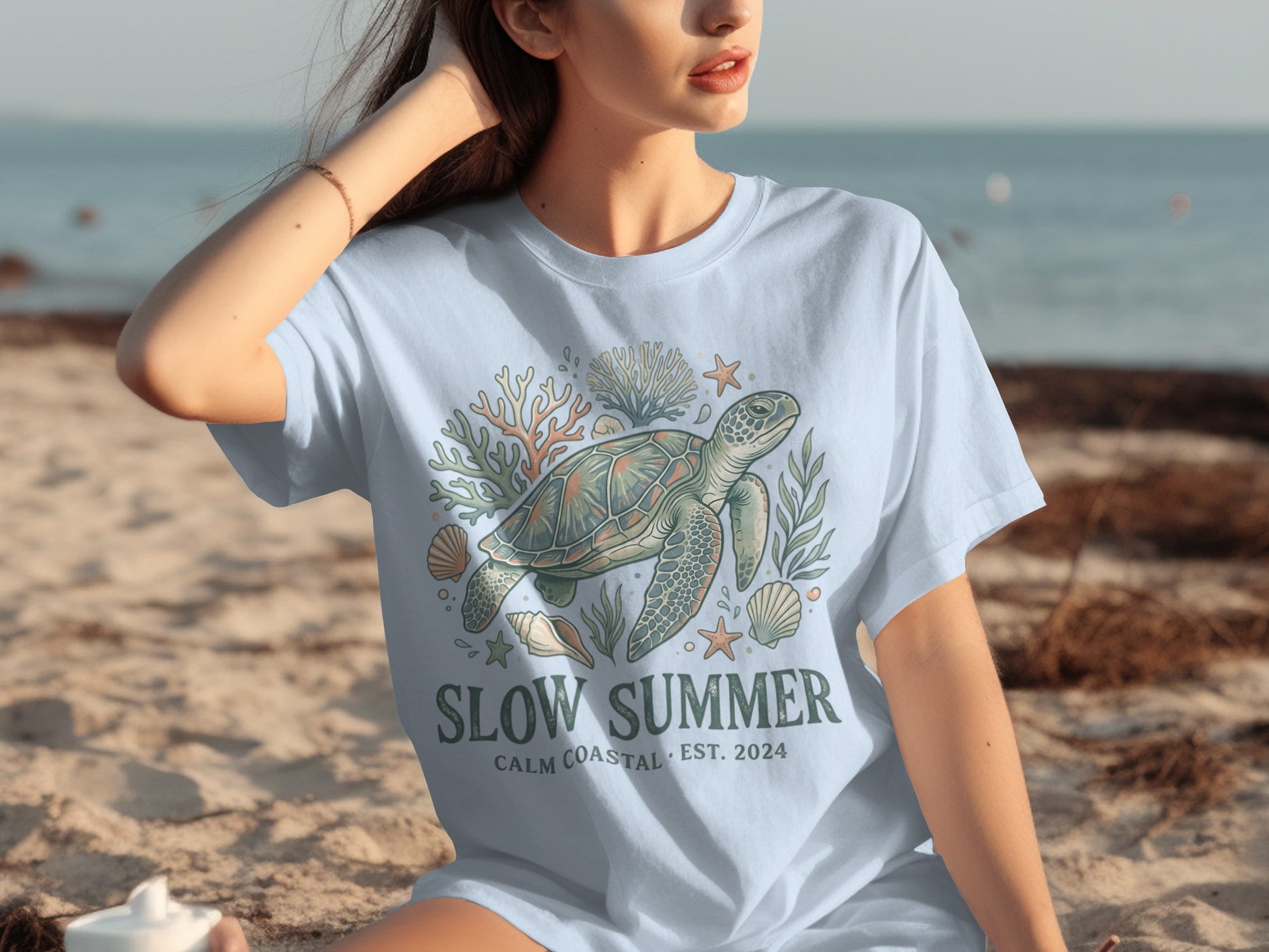 Light blue t-shirt with sea turtle, coral, and shell graphic; "Slow Summer" text.