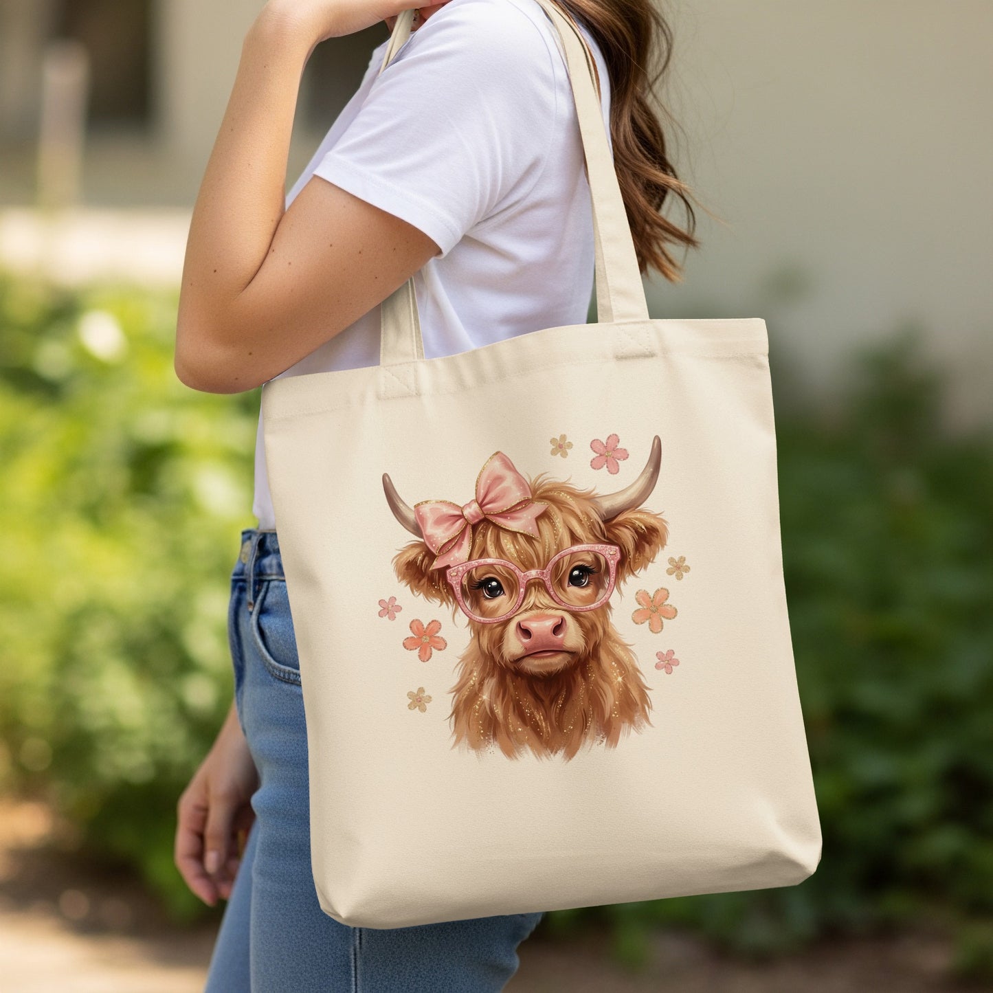 Tote bag with a Highland cow wearing pink glasses and a bow.