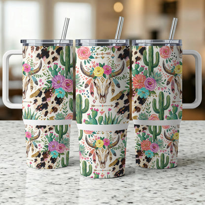 Cow skull and floral design on three tumblers with straws.