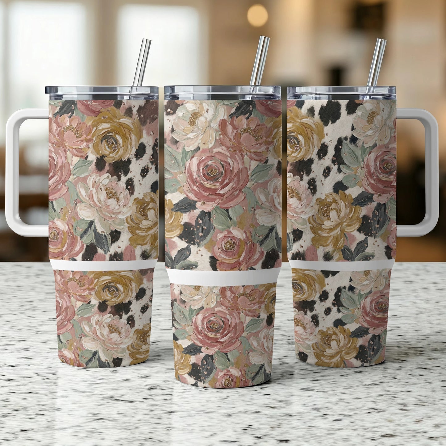 Floral and cow print tumbler with a handle and straw.