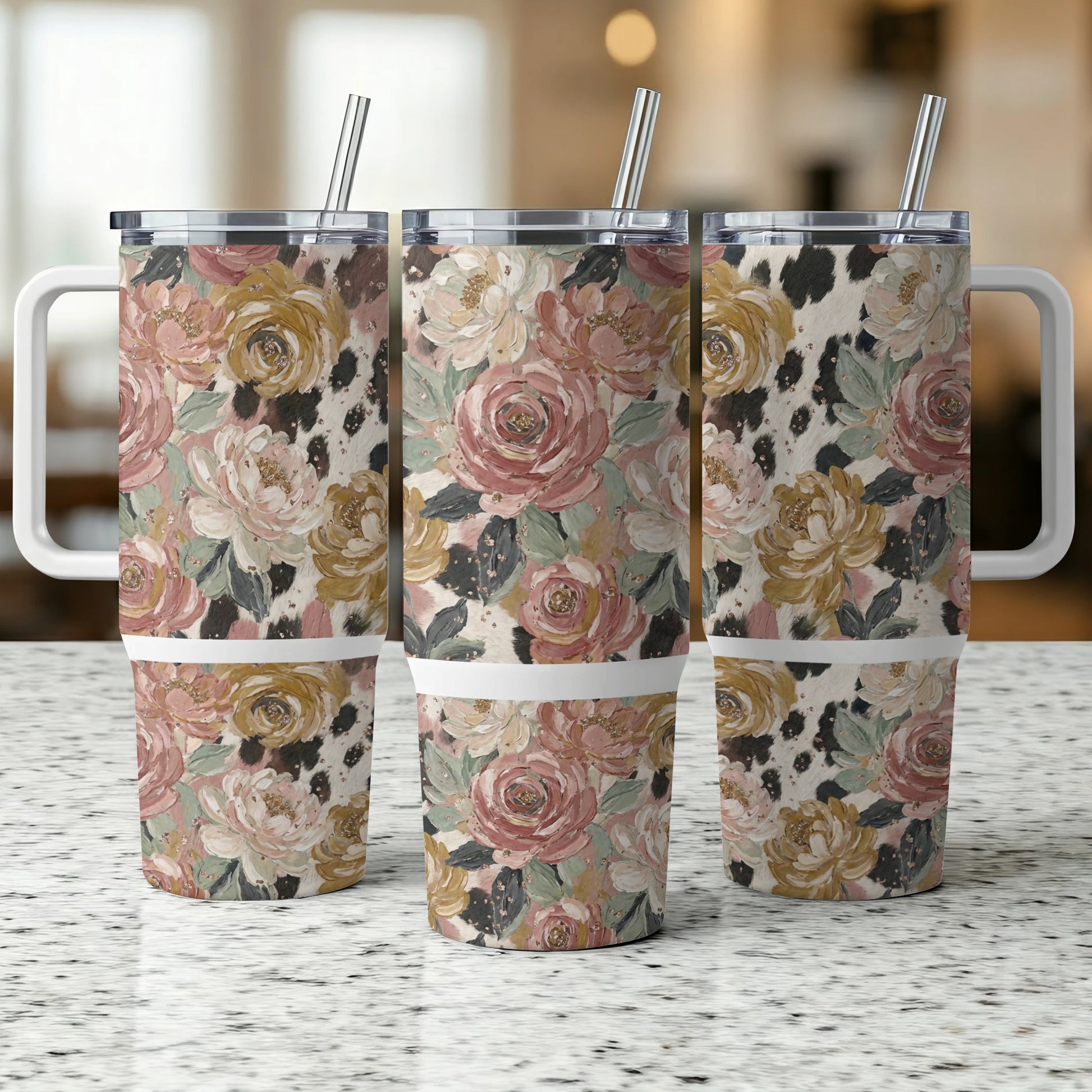 Floral and cow print tumbler with a handle and straw.