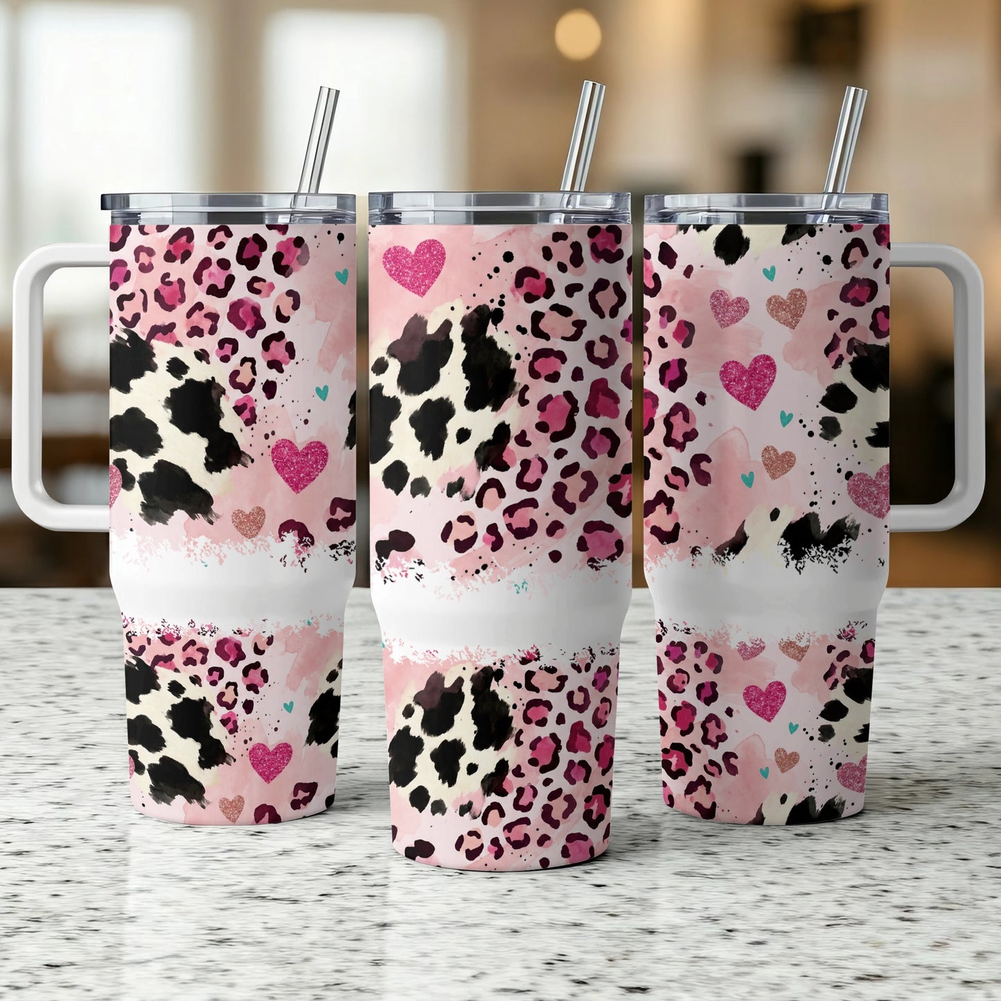 Three tumblers with pink leopard and cow print, hearts, and handles.