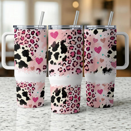 Three tumblers with pink leopard and cow print, hearts, and handles.