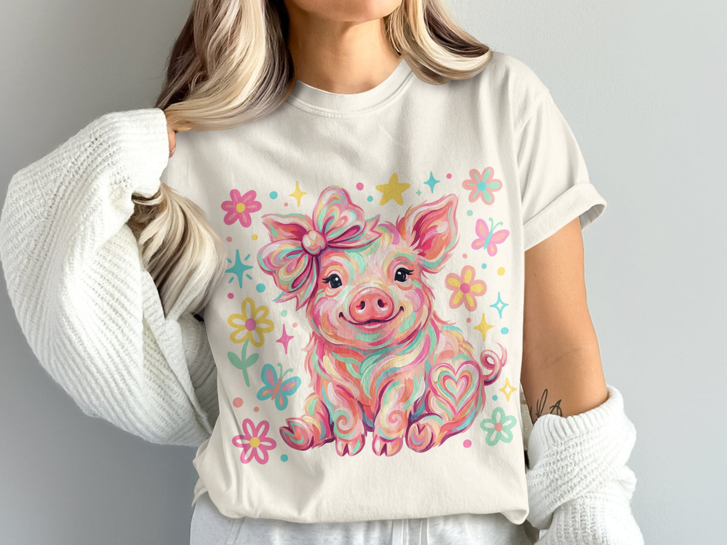 Pink watercolor pig with bow, butterflies, and flowers on a t-shirt.